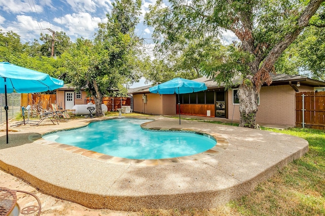 view of pool featuring a patio area and an outbuilding