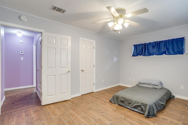 bedroom featuring hardwood / wood-style flooring and ceiling fan