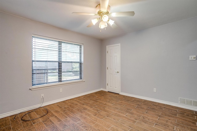 empty room with hardwood / wood-style floors and ceiling fan