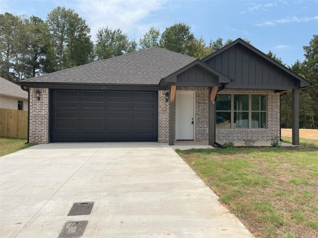 view of front of property featuring a garage and a front lawn