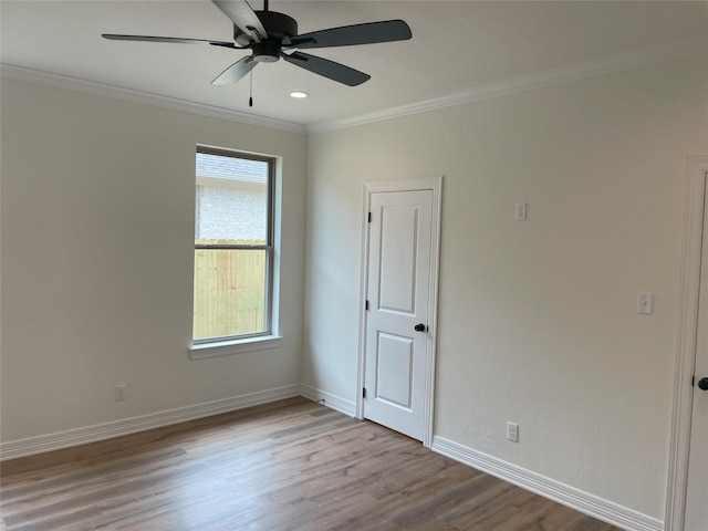 unfurnished room featuring crown molding, ceiling fan, and light hardwood / wood-style flooring