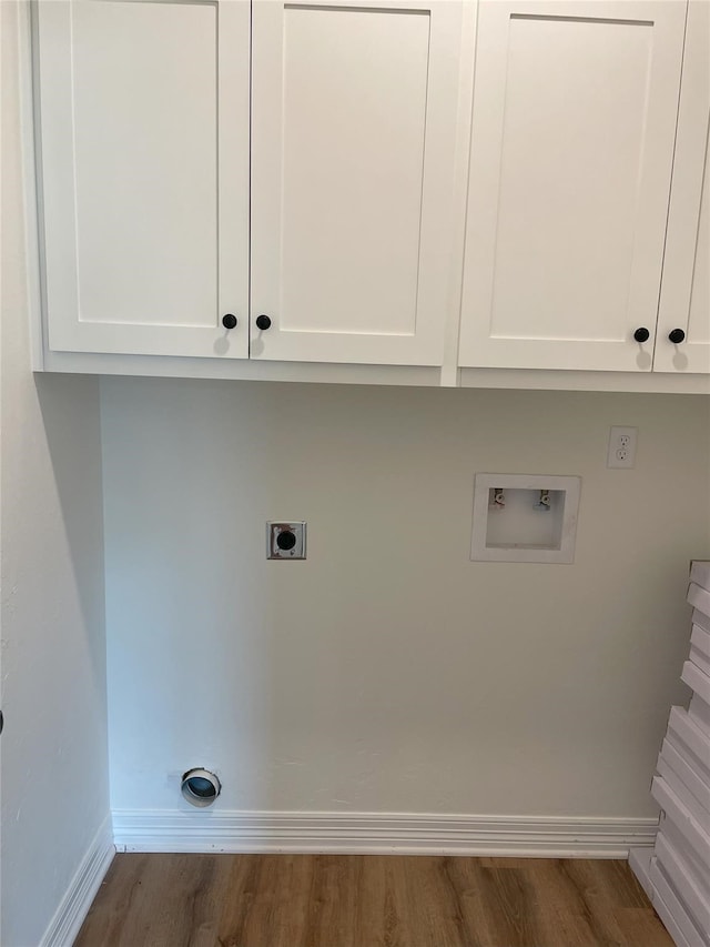 washroom with hookup for a washing machine, cabinets, dark wood-type flooring, and electric dryer hookup