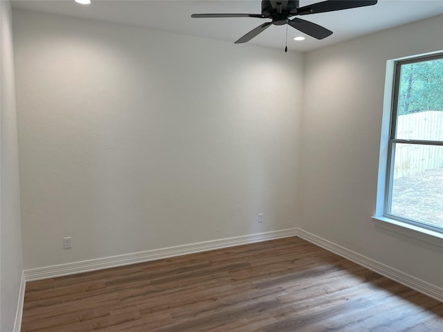 unfurnished room with wood-type flooring, ceiling fan, and a healthy amount of sunlight