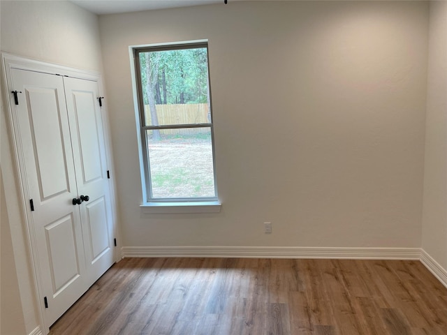 unfurnished room featuring plenty of natural light and light wood-type flooring