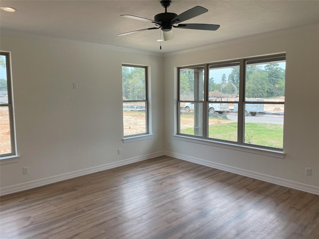 empty room featuring ceiling fan, ornamental molding, and hardwood / wood-style floors