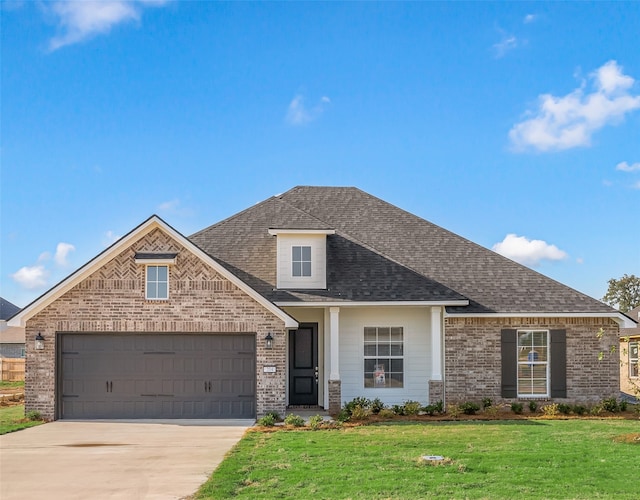 view of front facade with a garage and a front lawn