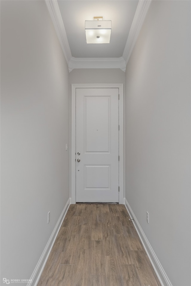 entryway with light wood-type flooring and ornamental molding