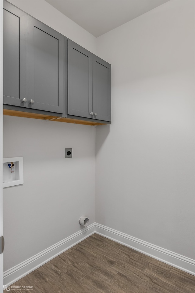 laundry area with hookup for an electric dryer, washer hookup, dark hardwood / wood-style floors, and cabinets