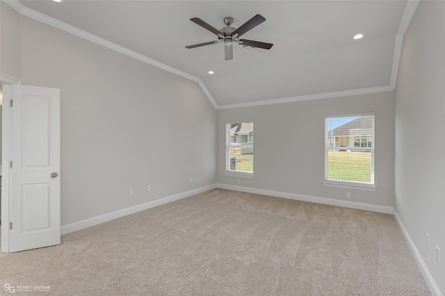 carpeted spare room featuring crown molding, ceiling fan, and lofted ceiling