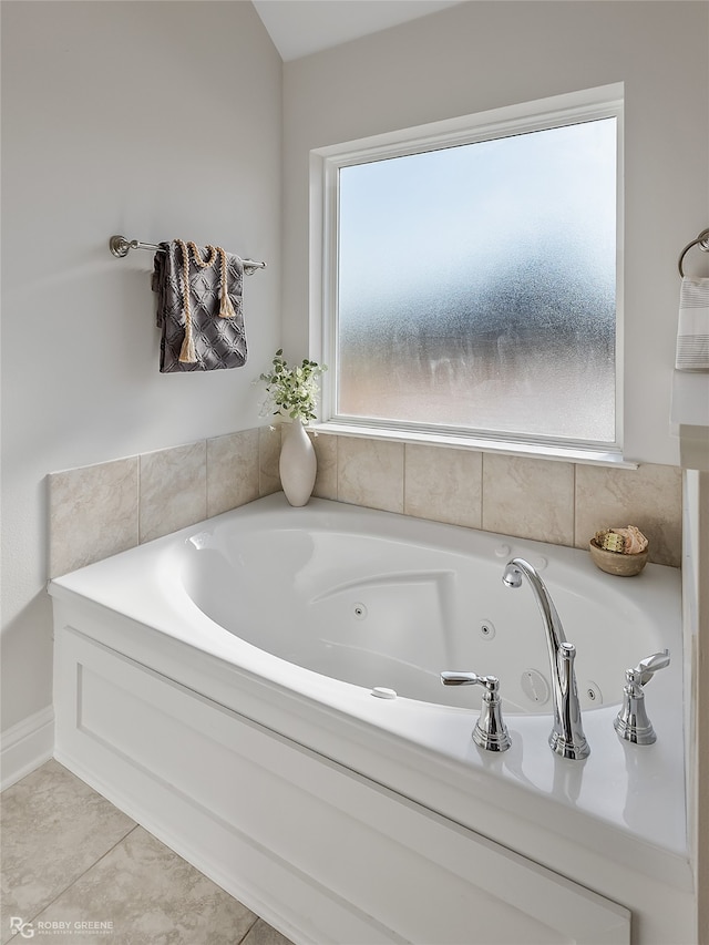 bathroom featuring a washtub, tile patterned floors, and plenty of natural light