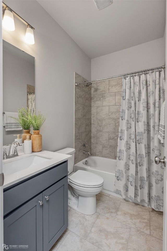 full bathroom with tile patterned flooring, shower / bath combination with curtain, toilet, and vanity