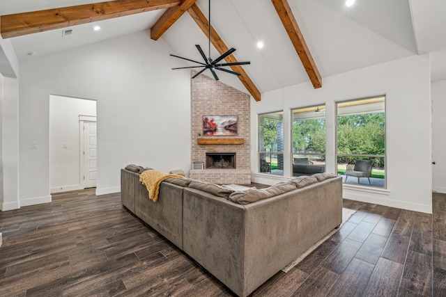 living room featuring a brick fireplace, dark hardwood / wood-style floors, high vaulted ceiling, and beamed ceiling