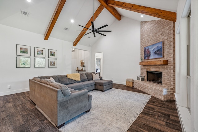 living room with a brick fireplace, beamed ceiling, dark wood-type flooring, and high vaulted ceiling