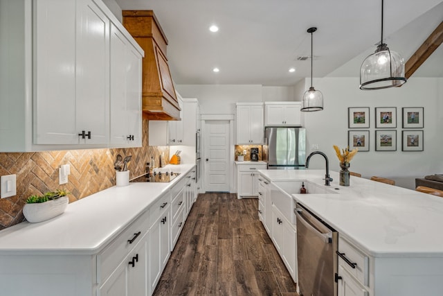 kitchen featuring sink, decorative light fixtures, white cabinetry, appliances with stainless steel finishes, and dark hardwood / wood-style floors