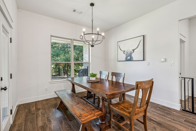 dining space featuring a notable chandelier and dark hardwood / wood-style flooring