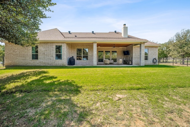 rear view of house with a yard and a patio