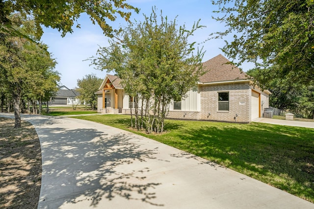 view of front of house with a garage and a front lawn