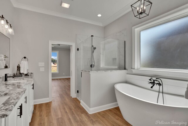 bathroom with vanity, an inviting chandelier, separate shower and tub, ornamental molding, and wood-type flooring