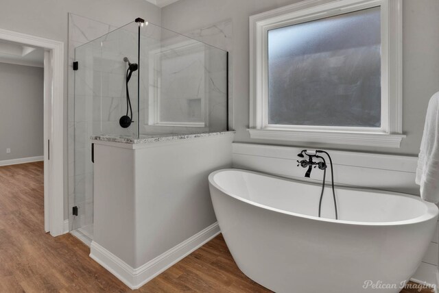 bathroom featuring separate shower and tub and hardwood / wood-style floors