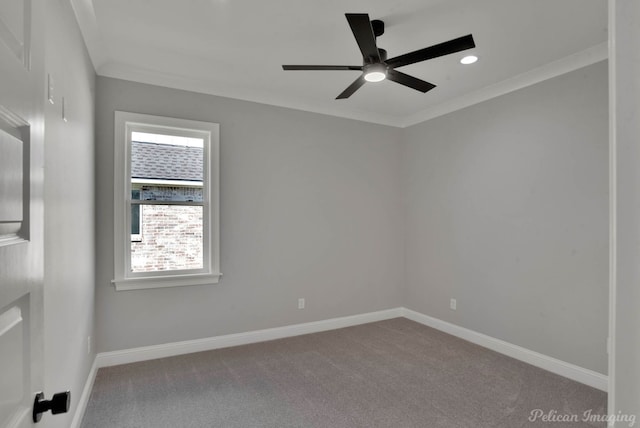 carpeted spare room featuring ceiling fan and crown molding