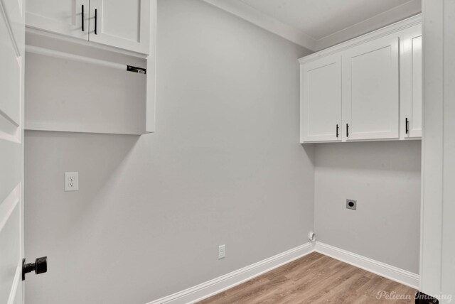 washroom with crown molding, light hardwood / wood-style flooring, cabinets, and hookup for an electric dryer