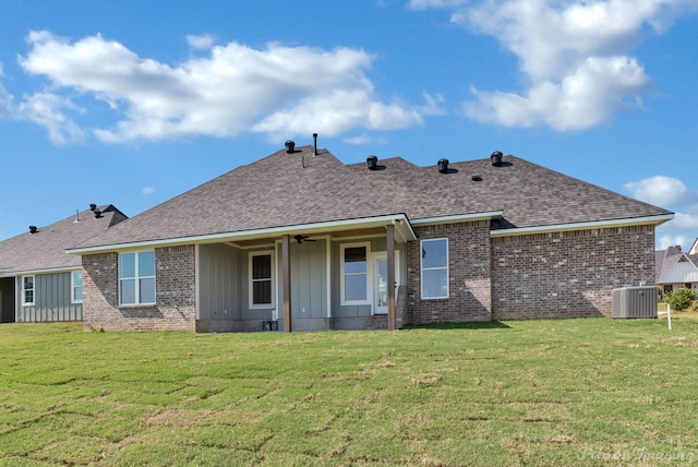 back of property with ceiling fan, a yard, and central AC