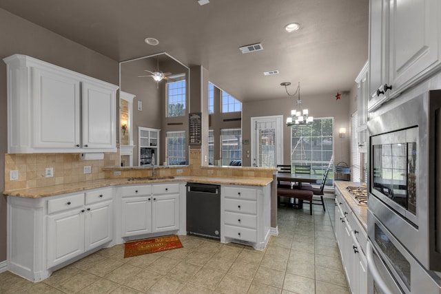 kitchen with kitchen peninsula, white cabinetry, and stainless steel appliances