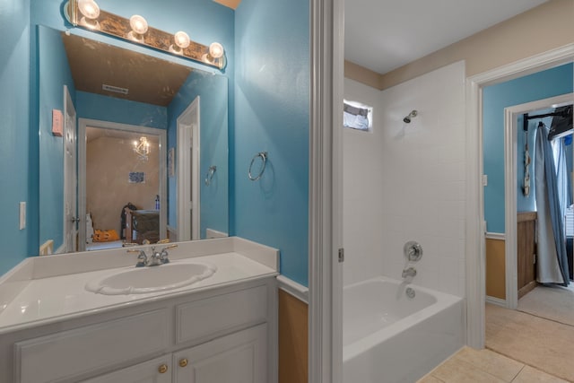 bathroom featuring tile patterned floors, bathtub / shower combination, and vanity