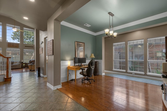 office space featuring hardwood / wood-style flooring, ceiling fan with notable chandelier, and crown molding