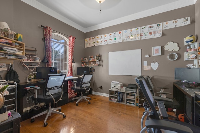 home office with light wood-type flooring, crown molding, and ceiling fan