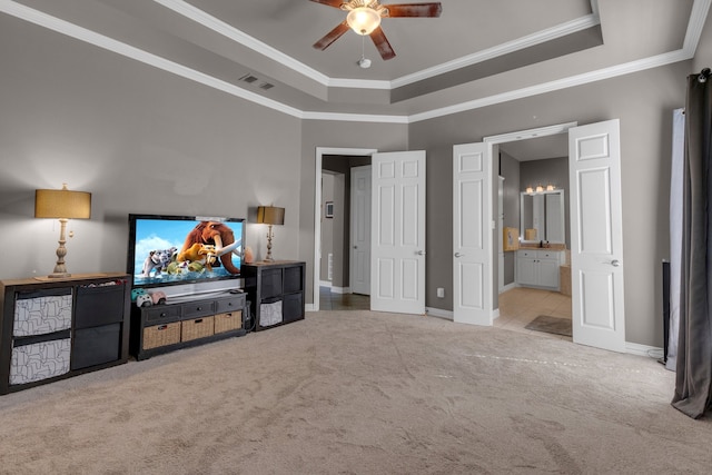 interior space featuring ceiling fan, a tray ceiling, and crown molding