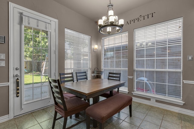 tiled dining space with a notable chandelier