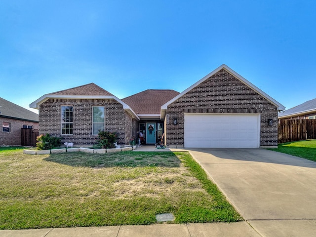 view of front of house with a garage and a front lawn