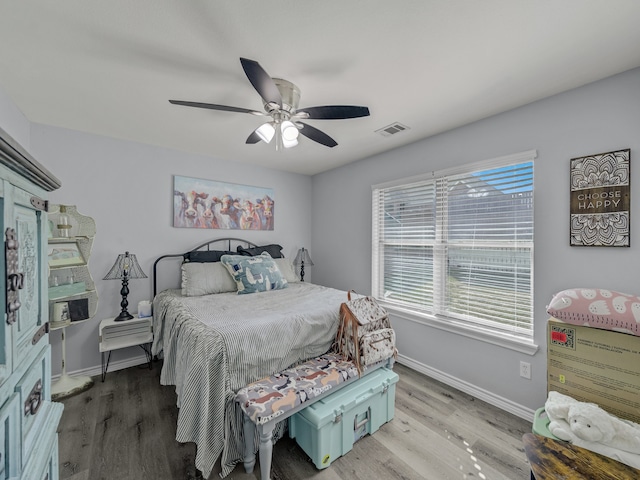 bedroom with wood-type flooring and ceiling fan