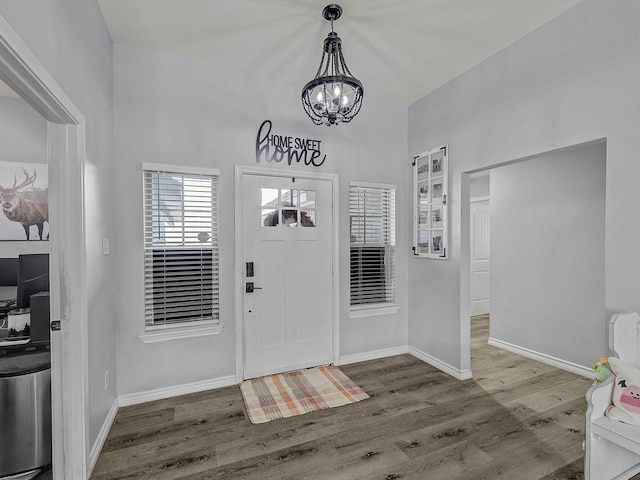 entryway with hardwood / wood-style flooring and an inviting chandelier