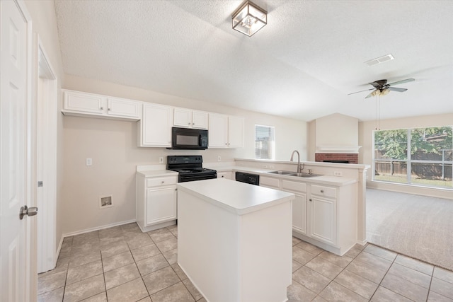 kitchen with ceiling fan, sink, white cabinetry, black appliances, and a center island