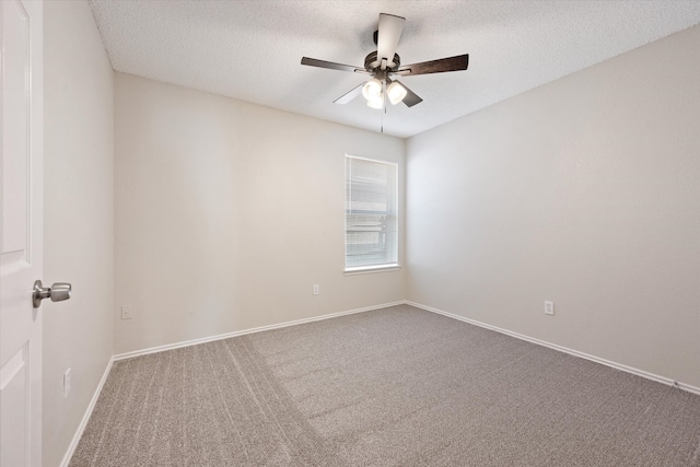 carpeted spare room with a textured ceiling and ceiling fan