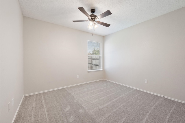 spare room featuring a textured ceiling, ceiling fan, and carpet flooring