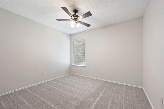 spare room with carpet, a textured ceiling, and ceiling fan