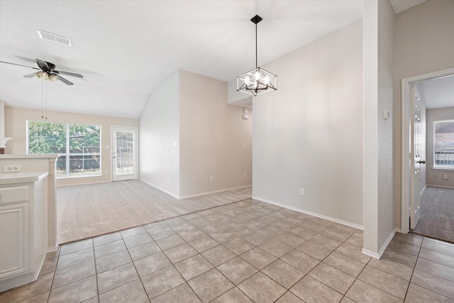 interior space with light carpet, ceiling fan with notable chandelier, and lofted ceiling