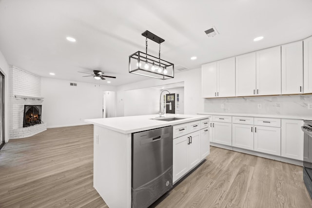 kitchen featuring a kitchen island with sink, appliances with stainless steel finishes, light hardwood / wood-style flooring, and white cabinetry