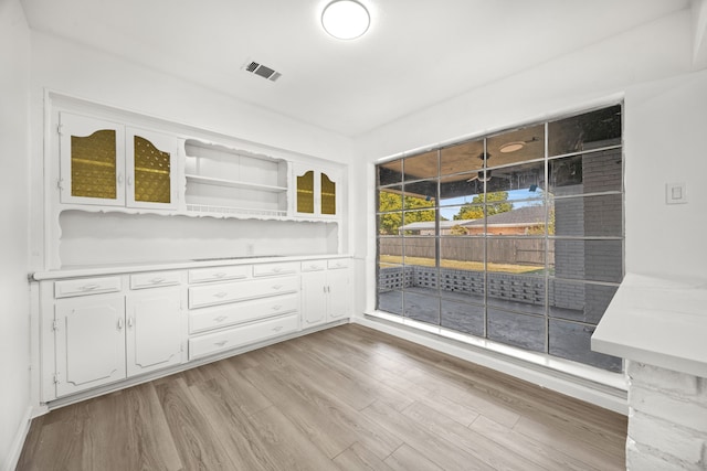 unfurnished dining area with light wood-type flooring