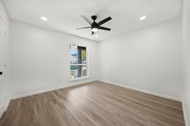 spare room with ceiling fan and light wood-type flooring