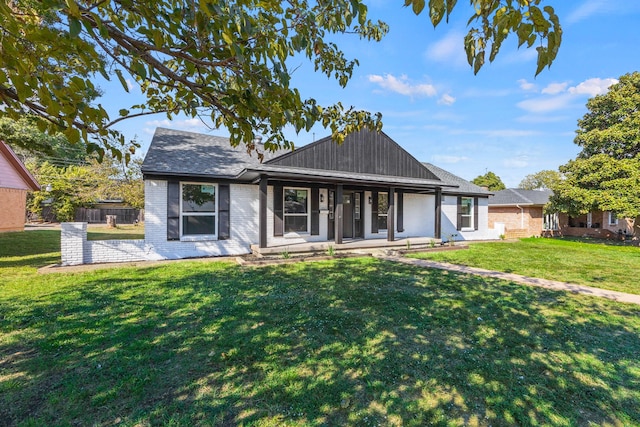 back of house with a lawn