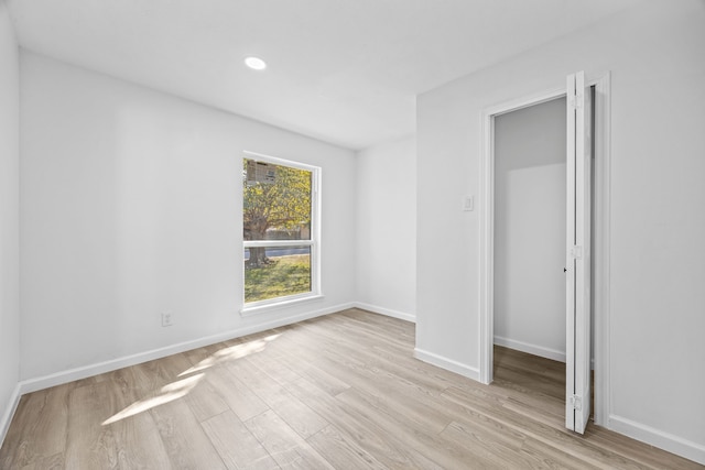 unfurnished bedroom featuring a closet and light hardwood / wood-style floors