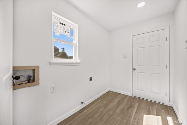 washroom with hookup for a washing machine, hardwood / wood-style flooring, and electric dryer hookup