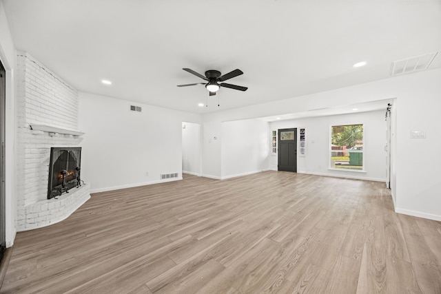 unfurnished living room with a fireplace, light hardwood / wood-style floors, and ceiling fan