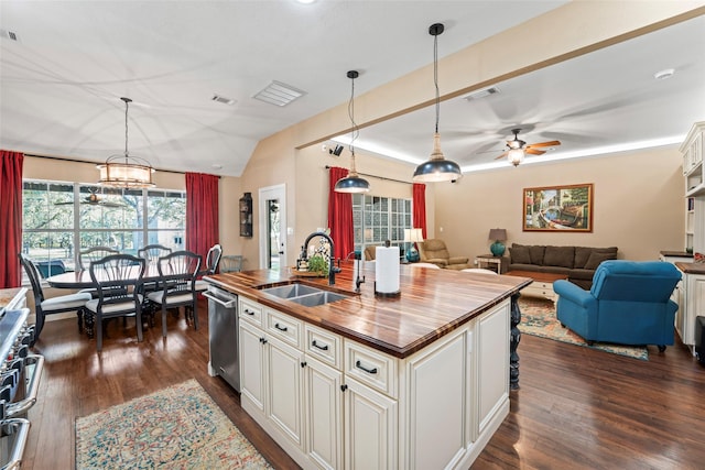 kitchen with ceiling fan, dark hardwood / wood-style floors, a center island with sink, sink, and appliances with stainless steel finishes