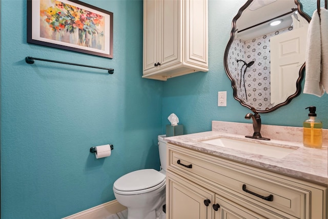 bathroom with toilet and vanity