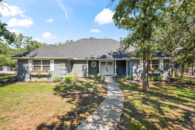 single story home with covered porch and a front yard